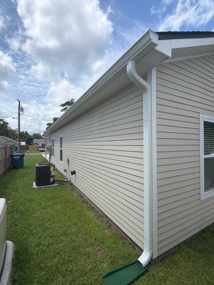 White home side wall with seamless gutters