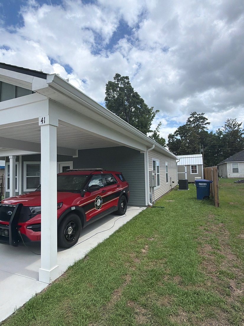White seamless gutters over a carport