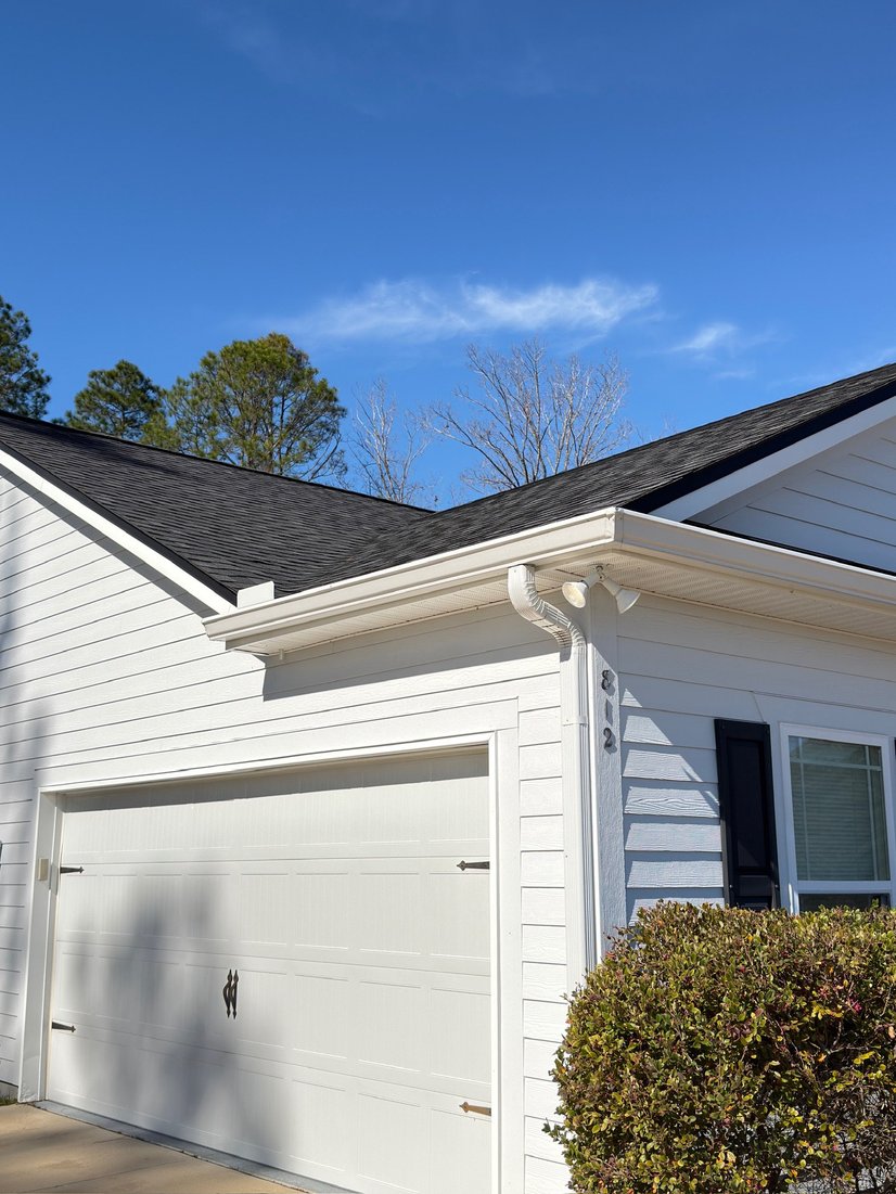 White home with an attached garage and seamless gutters