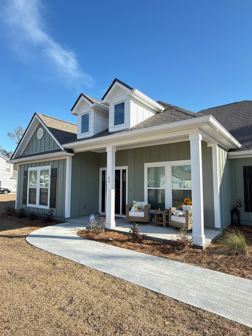 Two-story home with seamless gutters and a front porch