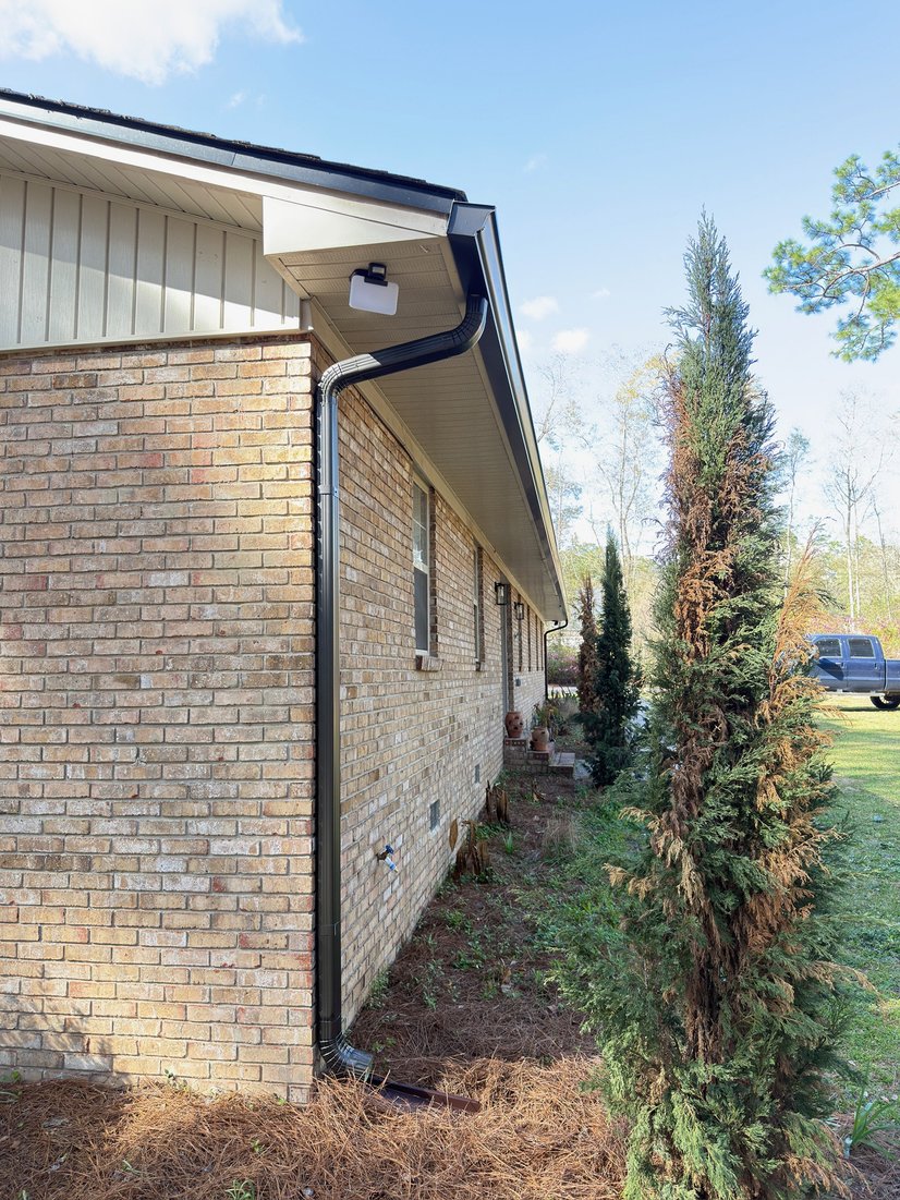 Brick home with seamless gutters along the eave