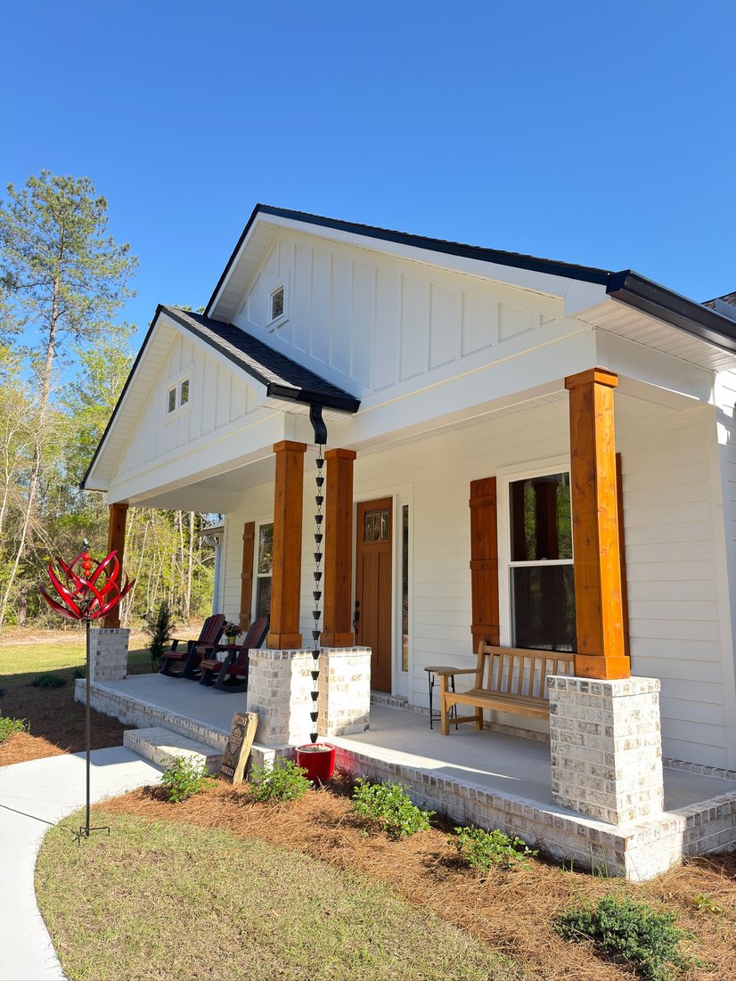 White home with a front porch and seamless gutters